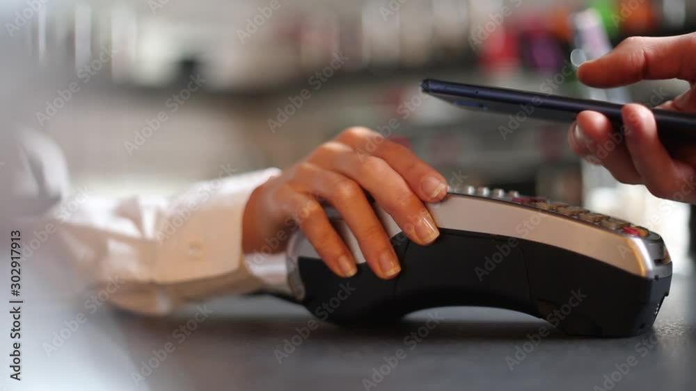 Contactless technology for accepting payments to a smartphone through the NFC. The seller in the cafe gives the POS - terminalfor payment to the client.