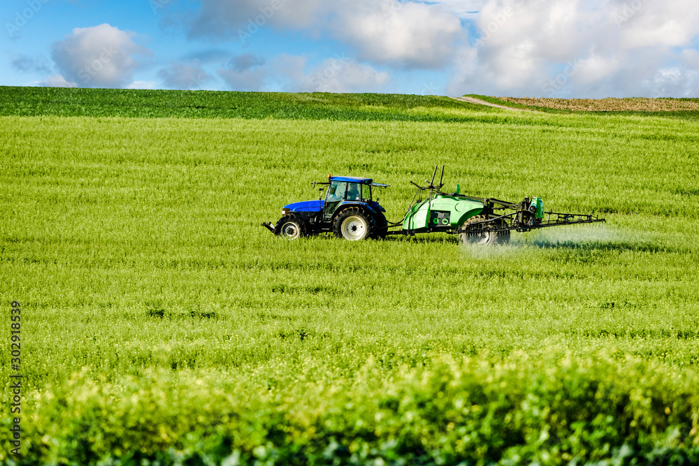 Fototapeta premium farmer spraying his fields in autumn