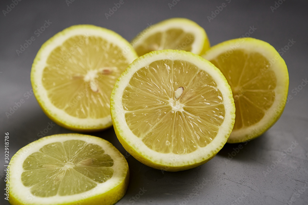 Cut lemon on a grey background. Healthy fruits. Cut lemon on a grey background. Healthy fruits.