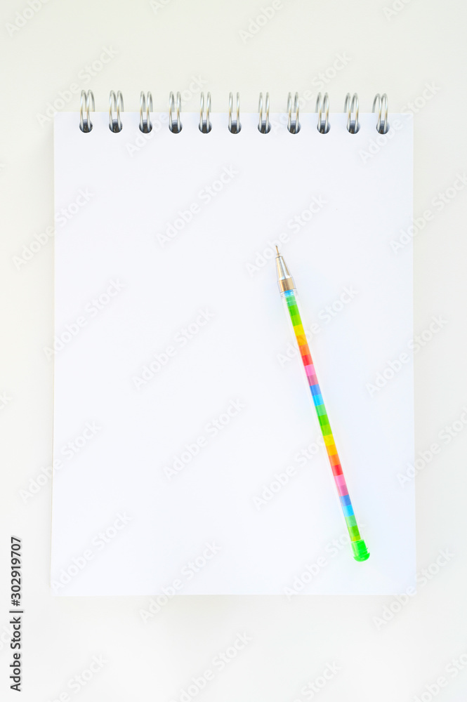 blank notebook and colorful pen on white background. office and back to school concept blank notebook and colorful pen on white background. office and back to school concept