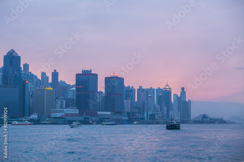 HONG KONG - JANUARY 8, 2015: Victoria harbor at evening. Skyscrapers in downtown of Hong Kong are visible from Kowloon side. The Hong Kong Island skyline. © Denys