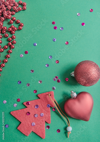 Christmas  tree  red decorations on a green background. place for text. view from above. flat lay