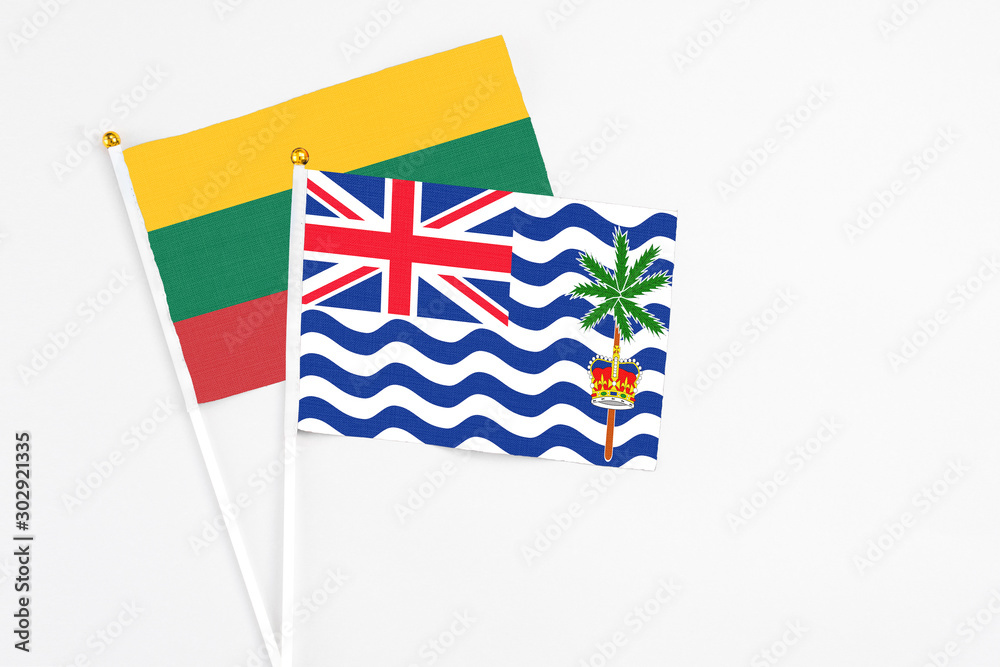 Fototapeta premium British Indian Ocean Territory and Lithuania stick flags on white background. High quality fabric, miniature national flag. Peaceful global concept.White floor for copy space.