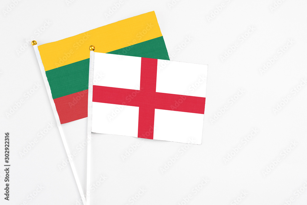 England and Lithuania stick flags on white background. High quality fabric, miniature national flag. Peaceful global concept.White floor for copy space.