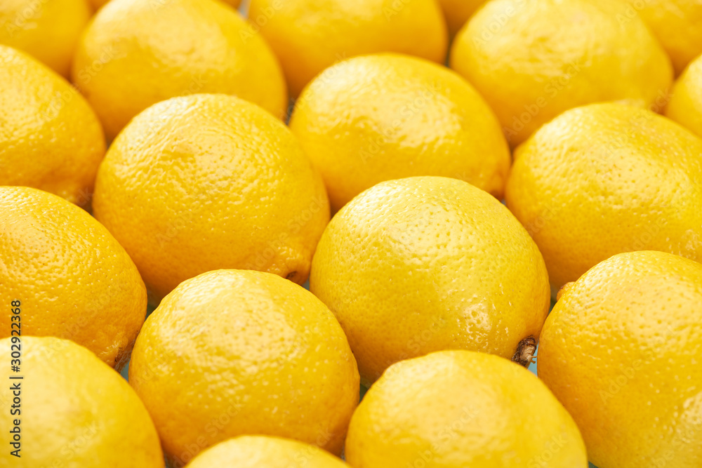 close up view of ripe yellow lemons on blue background close up view of ripe yellow lemons on blue background