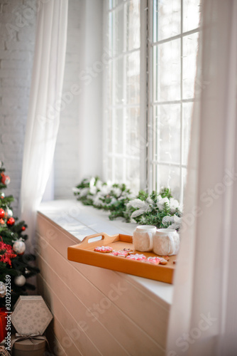 Beautiful holiday decorated room with Christmas tree with presents under it