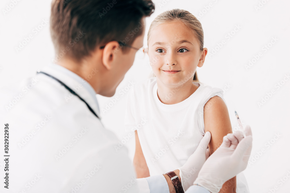 pediatrist in latex gloves doing injection to child isolated on white