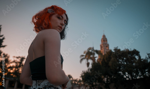 young rockabilly model with red hair looking down at the camera