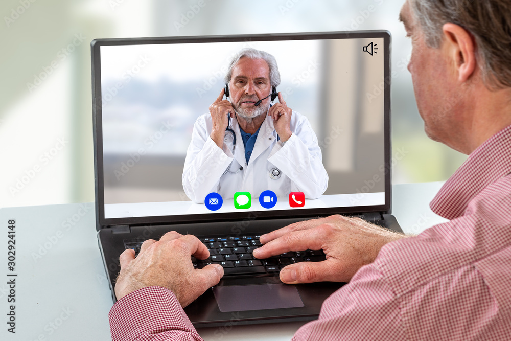 Telemedicine: hand of a man using computer with calling icon in here,phone ,song,camera,and messaging,and live chat ith doctor on screen on white Telemedicine: hand of a man using computer with calling icon in here,phone ,song,camera,and messaging,and live chat ith doctor on screen on white