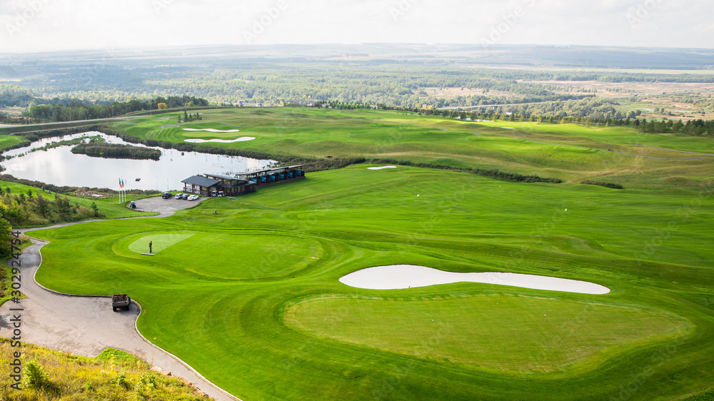 Aerial view of a green golf course, golf course on a sunny day Aerial view of a green golf course, golf course on a sunny day