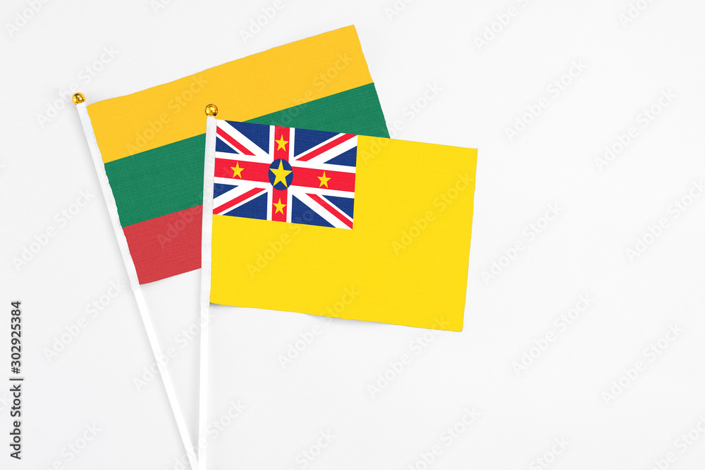 Niue and Lithuania stick flags on white background. High quality fabric, miniature national flag. Peaceful global concept.White floor for copy space. Niue and Lithuania stick flags on white background. High quality fabric, miniature national flag. Peaceful global concept.White floor for copy space.