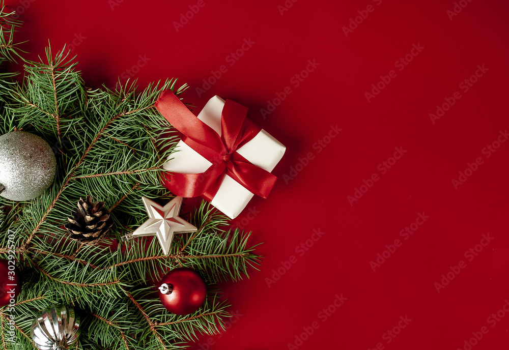 Christmas card with Christmas tree and gifts on a red background. with a place for congratulations.