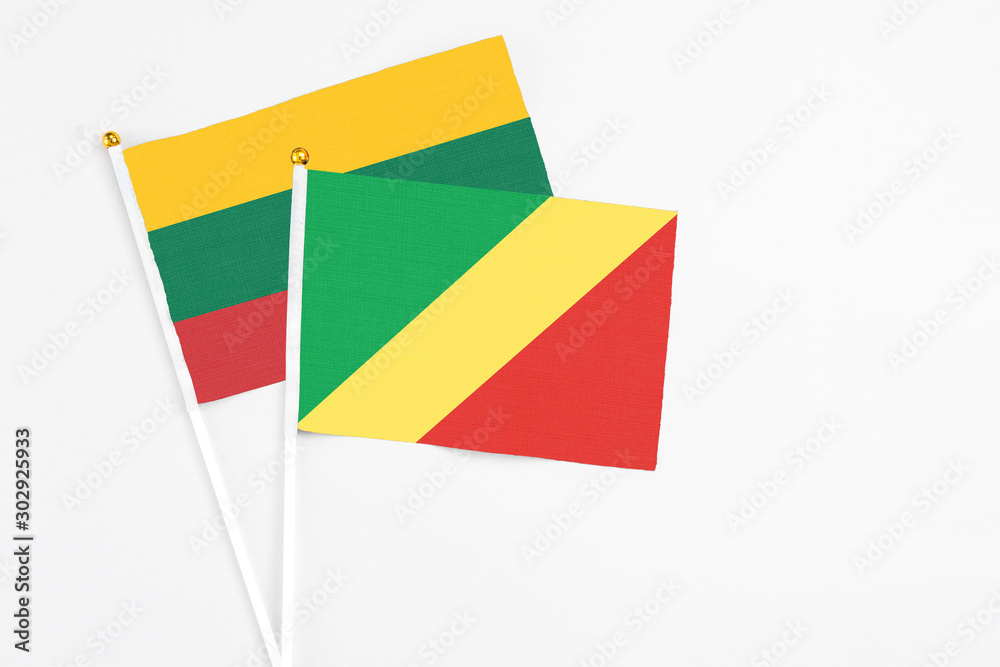 Fototapeta premium Republic Of The Congo and Lithuania stick flags on white background. High quality fabric, miniature national flag. Peaceful global concept.White floor for copy space.