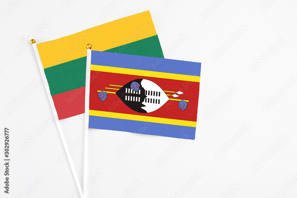 Swaziland and Lithuania stick flags on white background. High quality fabric, miniature national flag. Peaceful global concept.White floor for copy space. Swaziland and Lithuania stick flags on white background. High quality fabric, miniature national flag. Peaceful global concept.White floor for copy space.