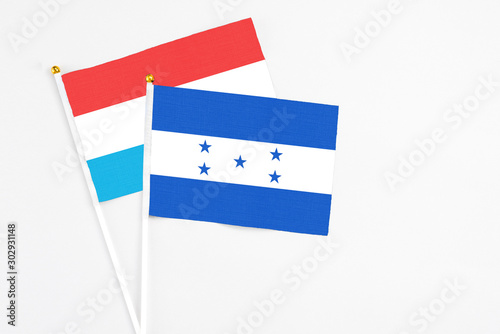 Free Download Honduras and Luxembourg stick flags on white background. High quality fabric, miniature national flag. Peaceful global concept.White floor for copy space. - GFXLoad