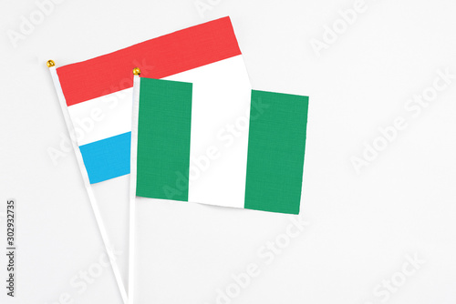 Free Download Nigeria and Luxembourg stick flags on white background. High quality fabric, miniature national flag. Peaceful global concept.White floor for copy space. - GFXLoad