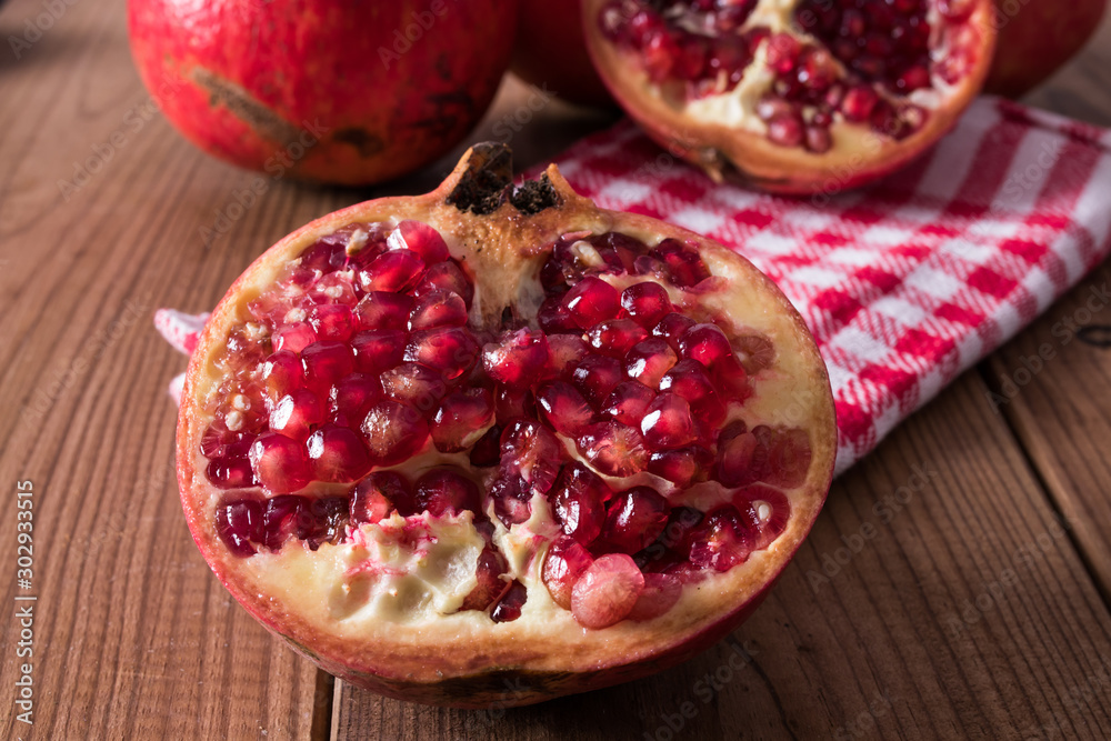 natural pomegranate on rustic wooden background natural pomegranate on rustic wooden background