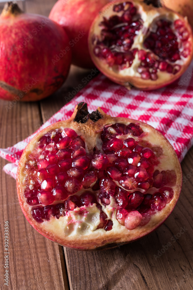 natural pomegranate on rustic wooden background natural pomegranate on rustic wooden background