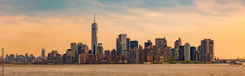 New York City cityscape with high skyscrapers on the shore of a lake under the colorful sky