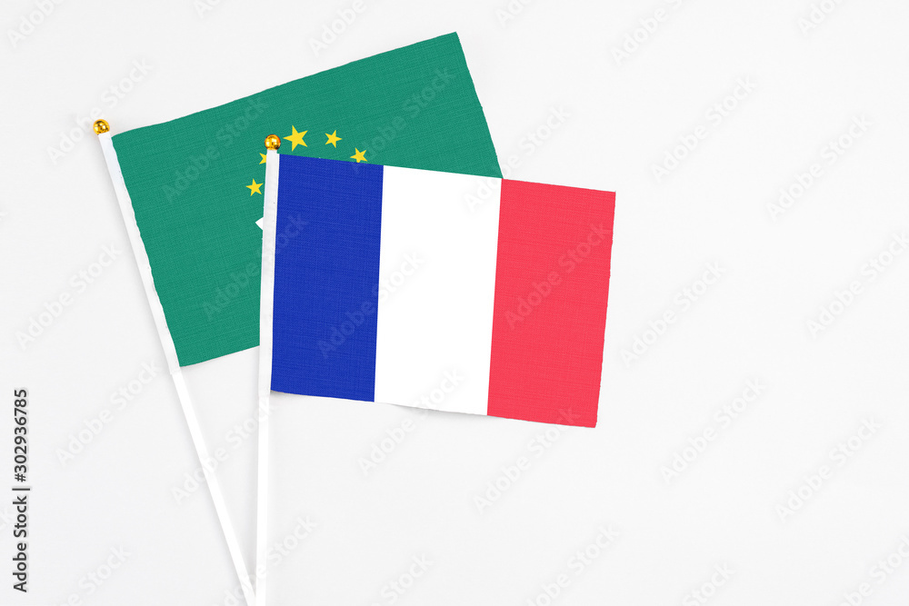 France and Macao stick flags on white background. High quality fabric, miniature national flag. Peaceful global concept.White floor for copy space. France and Macao stick flags on white background. High quality fabric, miniature national flag. Peaceful global concept.White floor for copy space.