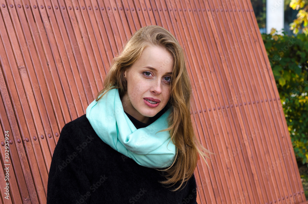 redhead girl with freckles with braces smiles joyfully. young ginger woman  with braces for bite correction. lady mysteriously looks at the camera.  Photos | Adobe Stock