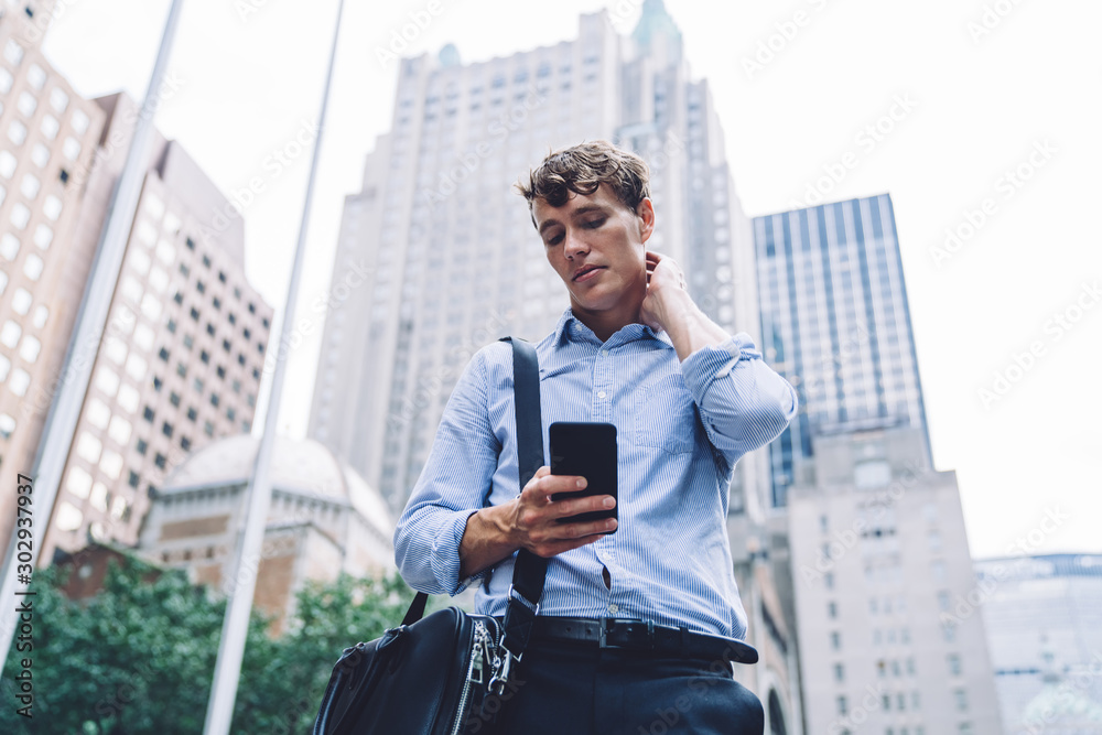 Young businessman standing chatting on phone in magapolis Young businessman standing chatting on phone in magapolis