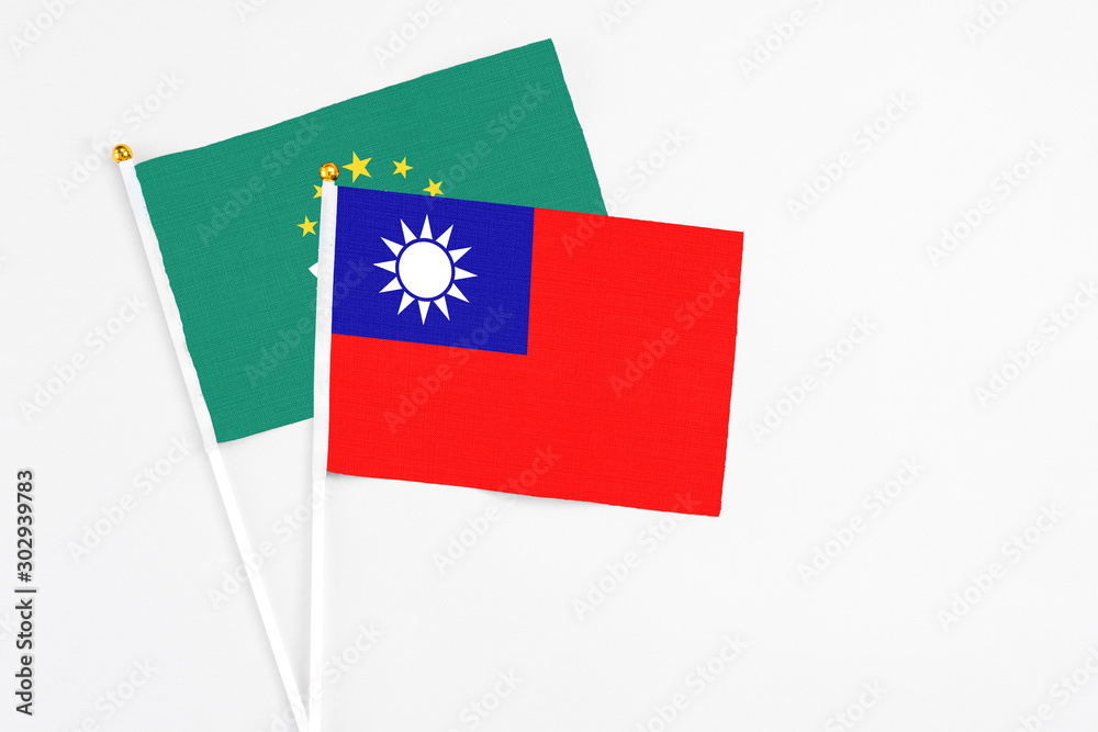 Taiwan and Macao stick flags on white background. High quality fabric, miniature national flag. Peaceful global concept.White floor for copy space.