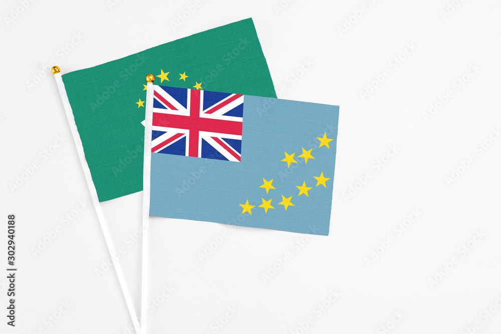 Tuvalu and Macao stick flags on white background. High quality fabric, miniature national flag. Peaceful global concept.White floor for copy space. Tuvalu and Macao stick flags on white background. High quality fabric, miniature national flag. Peaceful global concept.White floor for copy space.