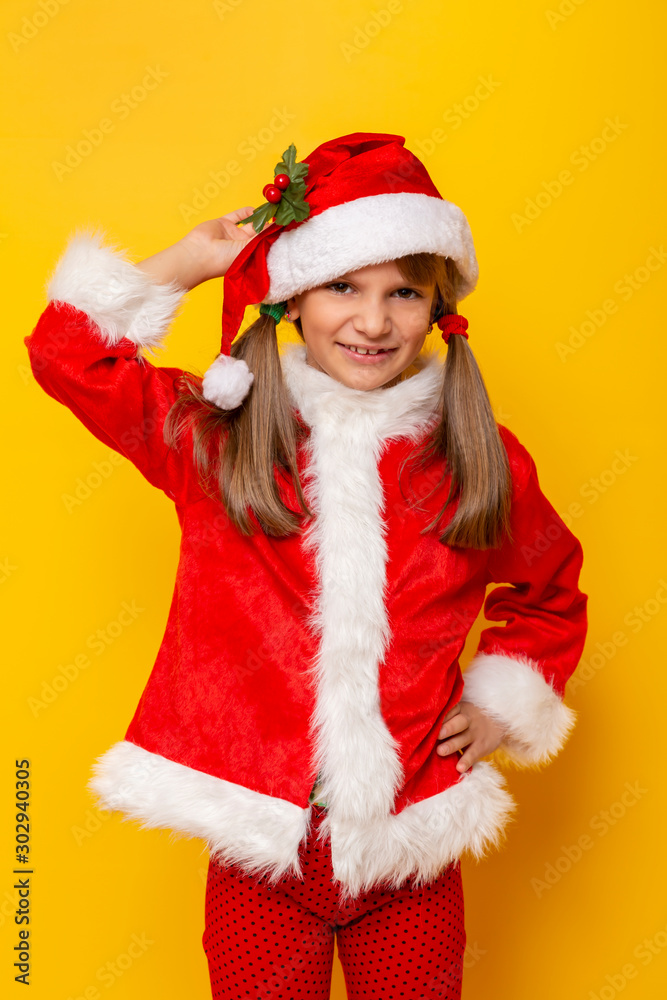 Child wearing Santa costume holding a mistletoe Child wearing Santa costume holding a mistletoe