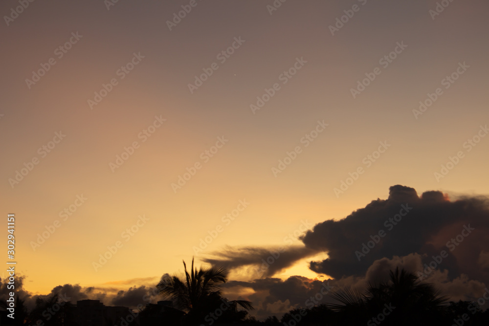 Scenic view of the evening sky during the sunset with clouds like a dragon letting out fire.