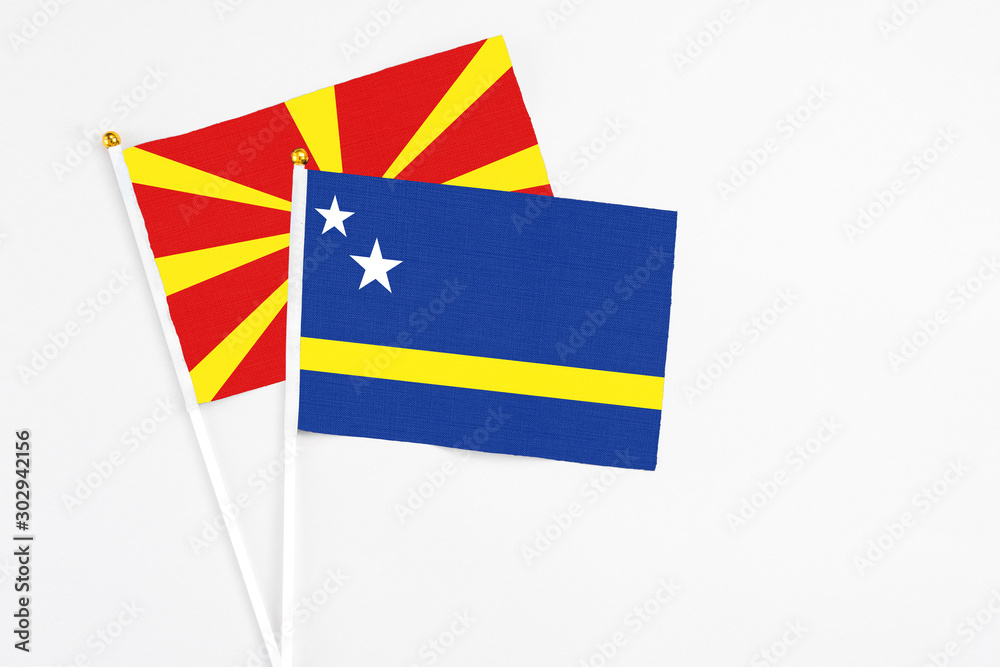 Curacao and Macedonia stick flags on white background. High quality fabric, miniature national flag. Peaceful global concept.White floor for copy space. Curacao and Macedonia stick flags on white background. High quality fabric, miniature national flag. Peaceful global concept.White floor for copy space.