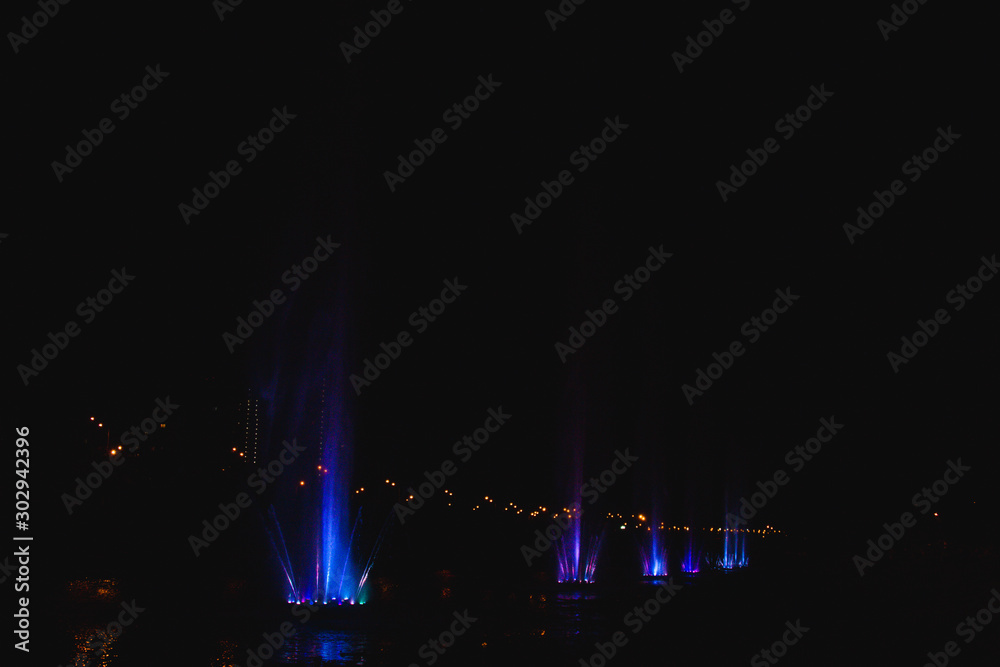 Ukraine. Kyiv - 05.06.2019 Amazing dancing fountain in the night illumination of rainbow color with colorful illuminations on the lake. Ukraine. Kyiv - 05.06.2019 Amazing dancing fountain in the night illumination of rainbow color with colorful illuminations on the lake.