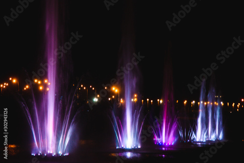 Ukraine. Kyiv - 05.06.2019 Amazing dancing fountain in the night illumination of rainbow color with colorful illuminations on the lake.