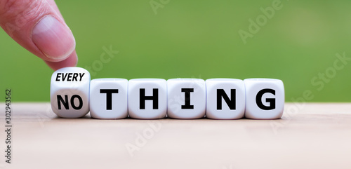 Hand turns a dice and changes the word "nothing" to "everything".