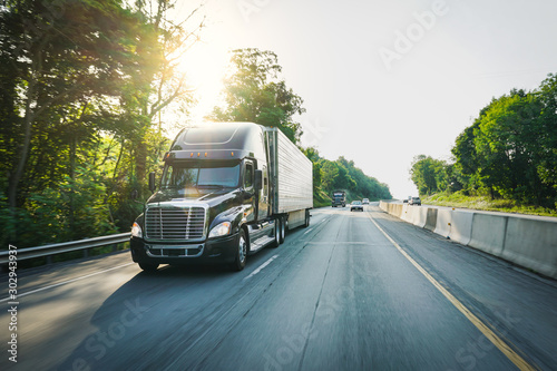 Semi-truck 18 wheeler on the highway delivering freight photo