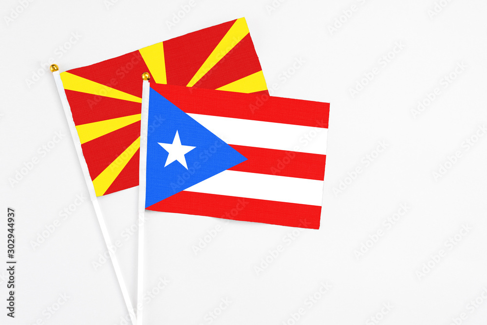 Obraz premium Puerto Rico and Macedonia stick flags on white background. High quality fabric, miniature national flag. Peaceful global concept.White floor for copy space.