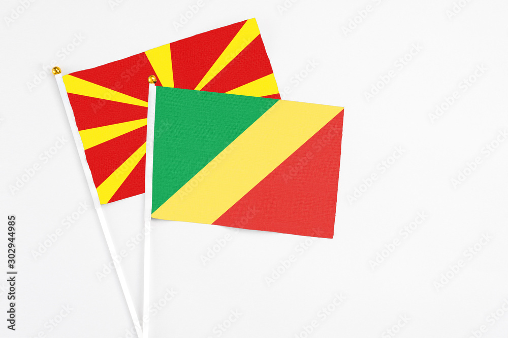 Republic Of The Congo and Macedonia stick flags on white background. High quality fabric, miniature national flag. Peaceful global concept.White floor for copy space.