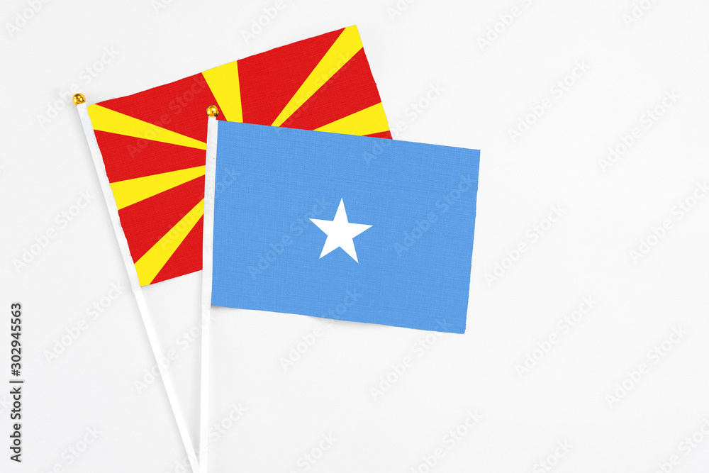 Somalia and Macedonia stick flags on white background. High quality fabric, miniature national flag. Peaceful global concept.White floor for copy space. Somalia and Macedonia stick flags on white background. High quality fabric, miniature national flag. Peaceful global concept.White floor for copy space.