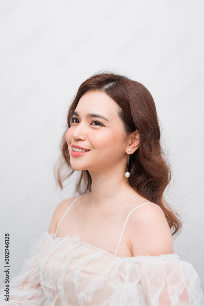 Beautiful smiling young asian woman with clean, fresh, glow, and perfect skin in white dress Beautiful smiling young asian woman with clean, fresh, glow, and perfect skin in white dress