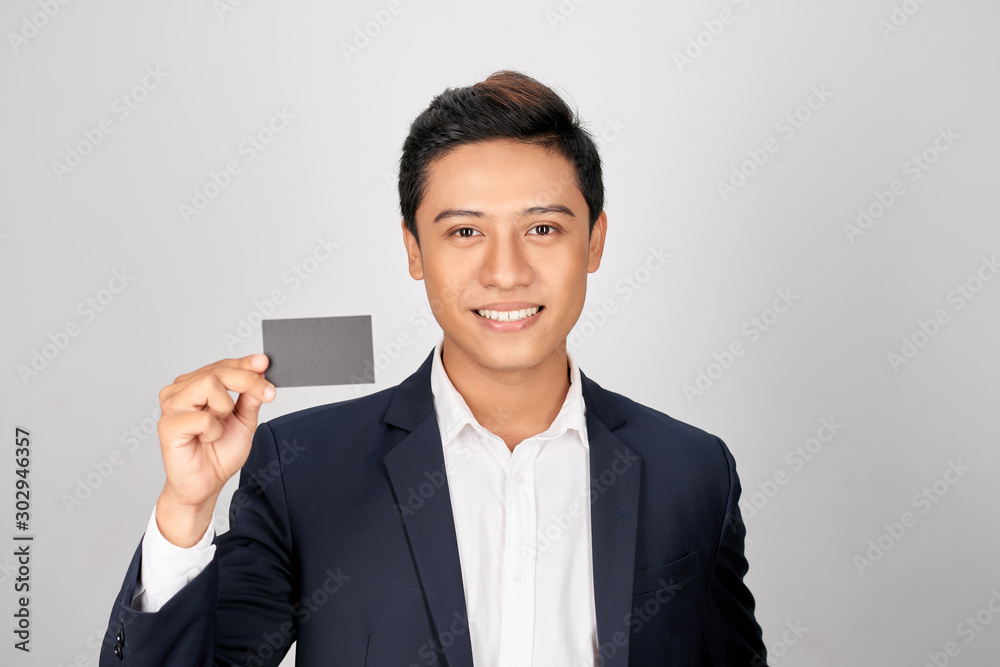 Portrait of young asian man showing a visit card Portrait of young asian man showing a visit card