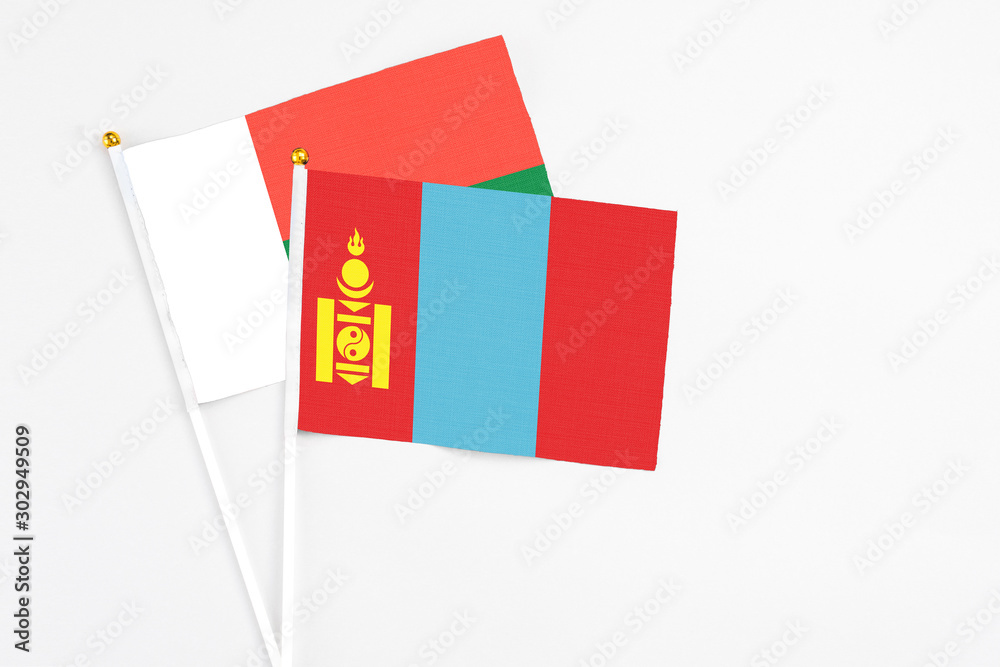 Mongolia and Madagascar stick flags on white background. High quality fabric, miniature national flag. Peaceful global concept.White floor for copy space. Mongolia and Madagascar stick flags on white background. High quality fabric, miniature national flag. Peaceful global concept.White floor for copy space.