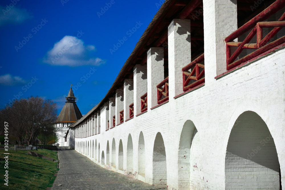 Vignette view of ancient wall with wooden railing and tower with wooden housetop