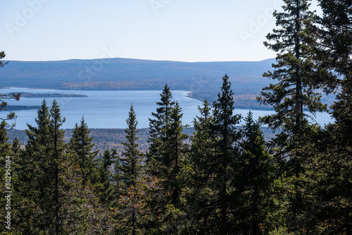 Amazing autumn wildlife on Mount Zyuratkul in the foreground a spruce forest through which you can see the lake