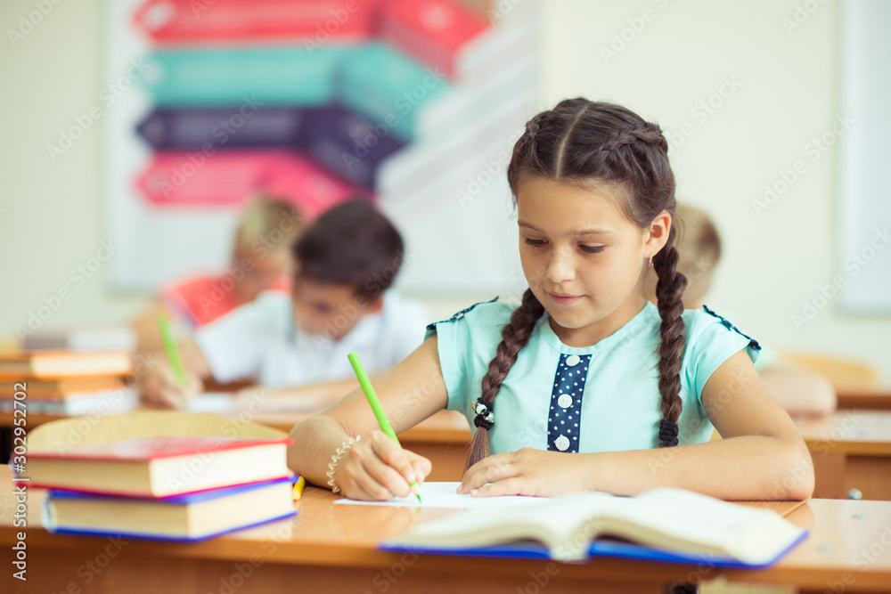 Happy clever children learning in classroom Happy clever children learning in classroom