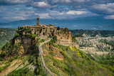 Civita Bagnoregio Perched on top of a hill among the valleys formed by Chiaro and Torbido streams, Civita appears clinged to the edge of a cliff where it dominates the wide desolated valley 