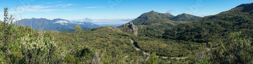 Itatiaia National Park, Brazil, and one of its beautiful mountain views. Panoramic shot with native vegetation, mountains and road BR-485. On background, the mountains of Serra Fina. photo