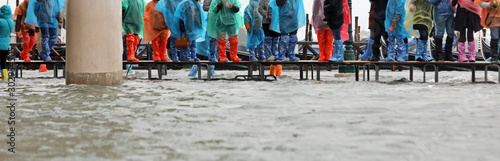 footbridge on the water during the flood in Venice in Italy photo