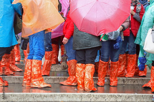 people with rain coat and gaiters during flood photo