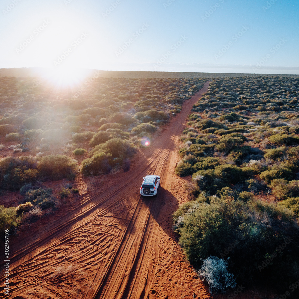 Off road desert adventure, car and tracks on sand in the Australian Outback.