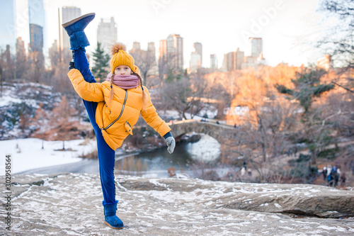 Adorable little girl with view of ice-rink in Central Park at New York City
